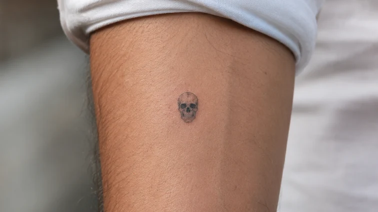 micro skull tattoo for men